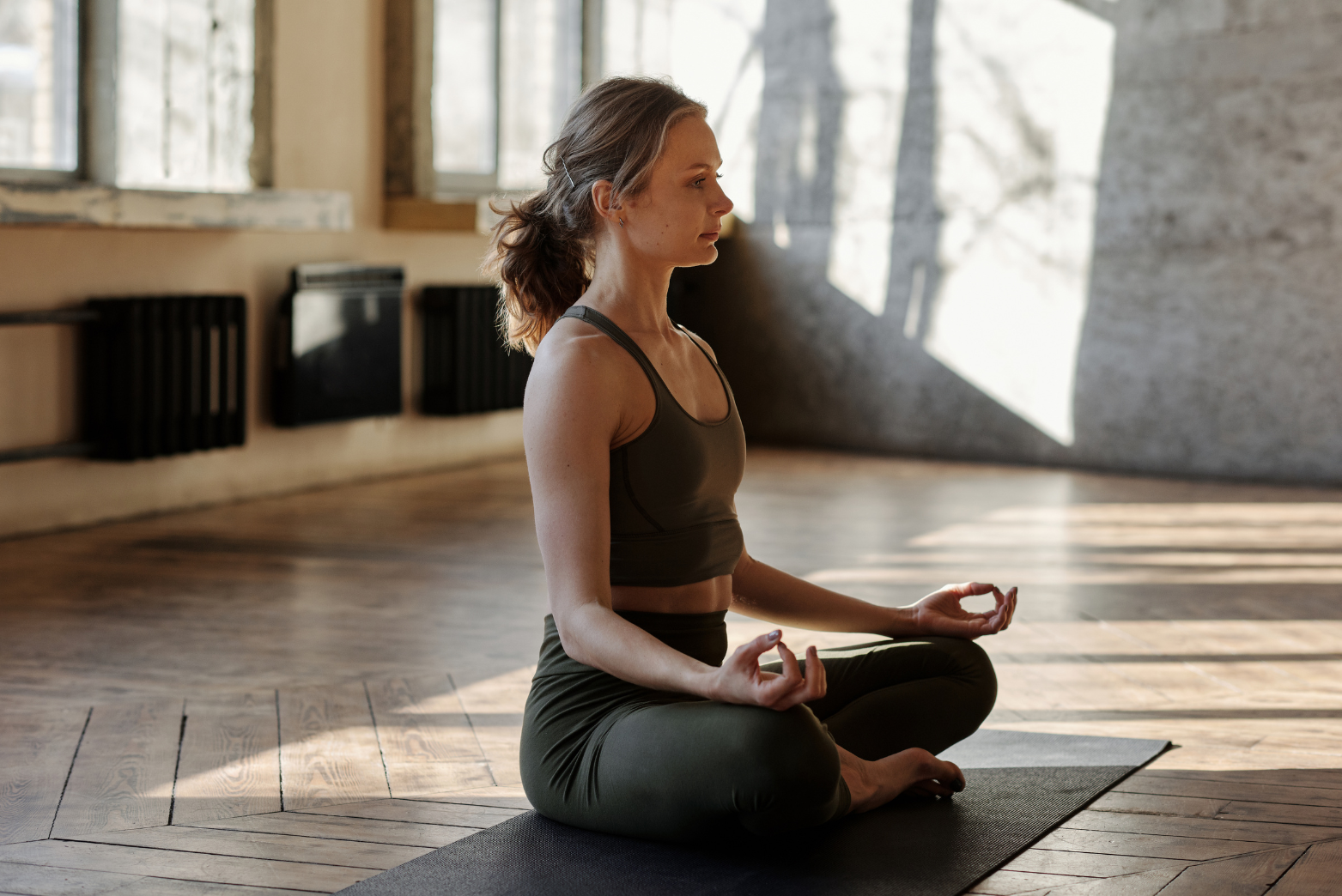 A woman meditating to improve gut health